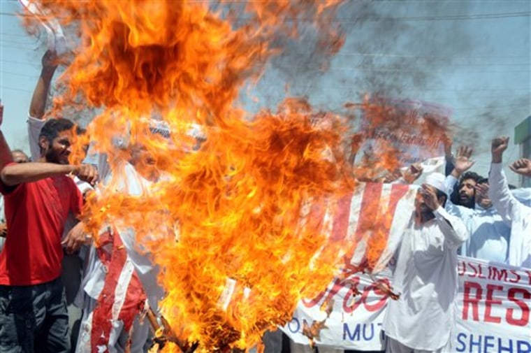 Pakistani protesters burn a representation of the U.S. flag during a rally to condemn U. S. drone attacks in Pakistani territory on Friday in Multan, Pakistan. 